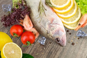 Fresh tasty fish for cooking dish on table with lemon