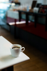 hot coffee on a table with cream being poured into it showing the texture