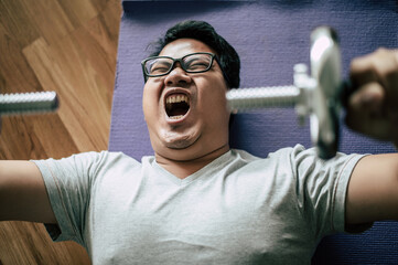 Young  fat man workout with dumbbell