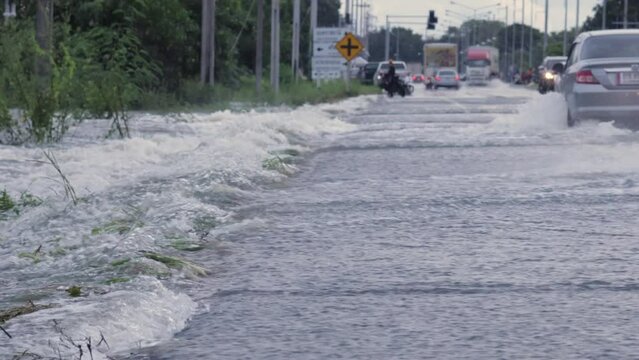 Video of the flooding, flooding the roads and making it impossible to go, Meng District, Thailand, on October 3, 2022, is a photograph from real flooding. With a slight color adjustment