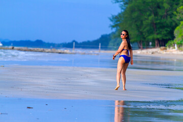 Woman shape big walk relax with swimsuit at beach