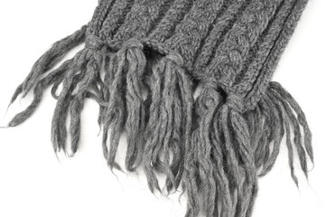 The knit scarf with a fringe on the tip is gray
