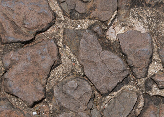 Stone Background Different shapes of brown stones are laid freely on the ground.