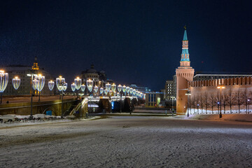 Naklejka na ściany i meble Spasskaya tower and winter Kremlin against the backdrop of street Christmas decorations.