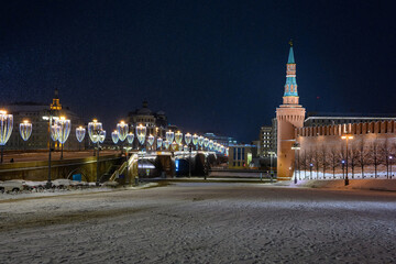 Fototapeta premium Spasskaya tower and winter Kremlin against the backdrop of street Christmas decorations.