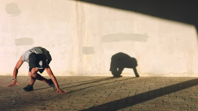 Black man shadow, street dance and hip hop artist performance in sunshine, creative power and freedom. Urban dancer, musician and youth training with energy, excited dancing and body action outdoors