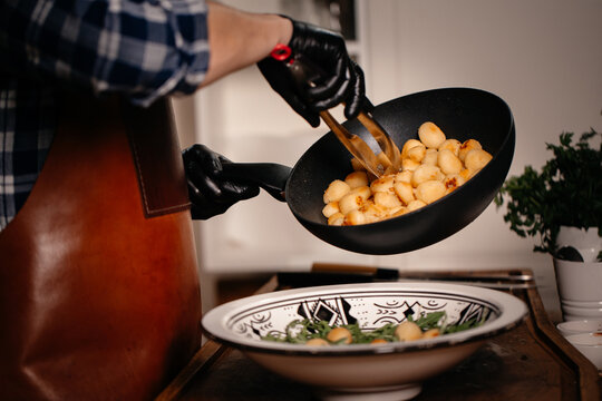 Person Holding Black Frying Pan And Making Food