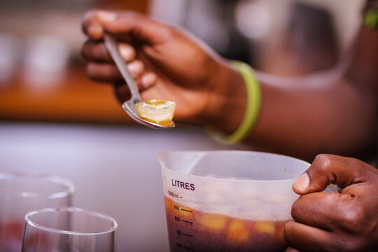 Person Holding Ice Cube On Spoon