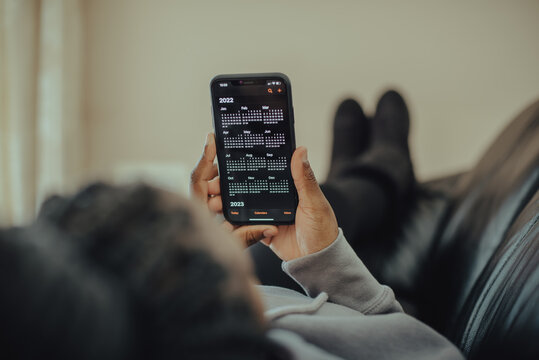 Person holding smartphone with calendar