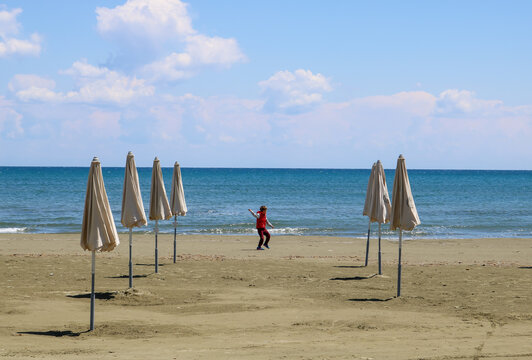Young boy throwing stones on the beach
