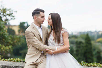 Young married couple having a photoshoot in the city