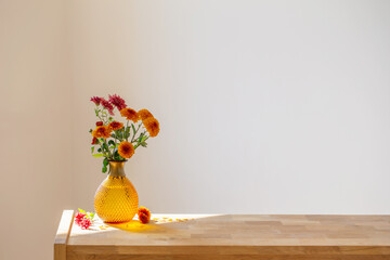 chrysanthemums in glass vase on white background