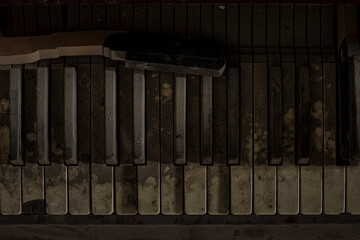 Close up urbex background of wood classical acoustic grand piano keyboard with sepia toned white...