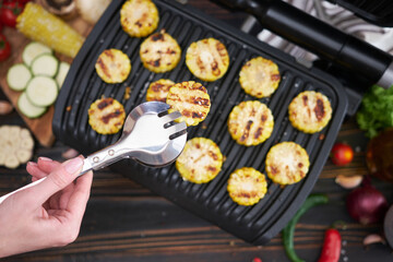 cooking at home on electric grill - sliced corn cobs