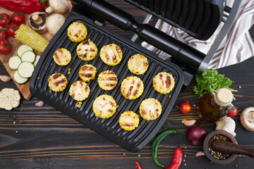 cooking at home on electric grill - sliced corn cobs