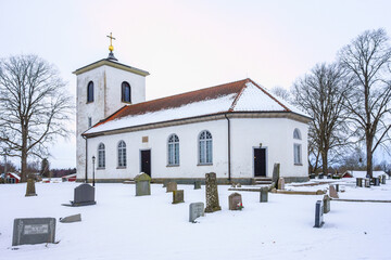 Fototapeta na wymiar Country church with snow in winter