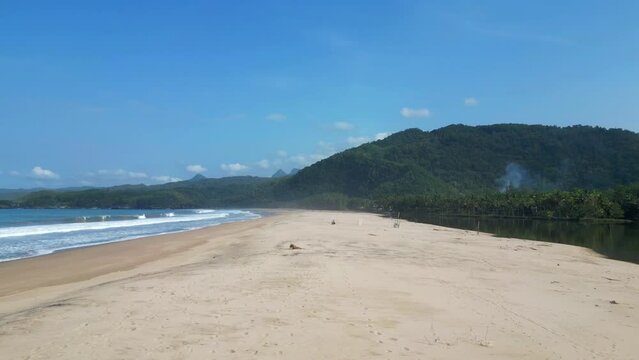 White Sandbar Divides Indonesian Ocean From Calm Lagoon Pacitan