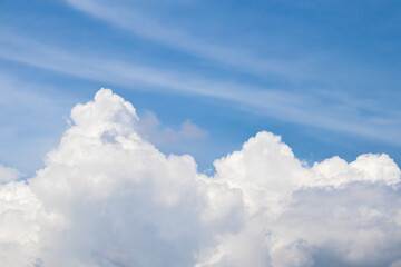 Fototapeta na wymiar The fluffy cloud in the light blue sky in sunny day. 