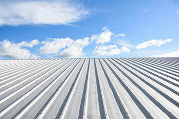 Fototapeta na wymiar metal sheet roofing on commercial construction with blue sky