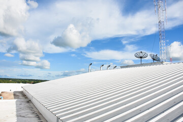 metal sheet roofing on commercial construction with blue sky © Aphisith