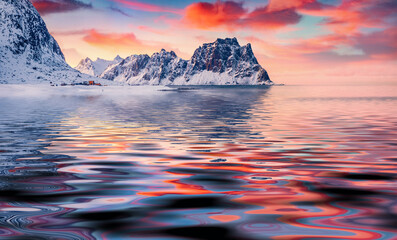 Majestic mountain peak reflected in the calm waters of Norwegian sea. Stunning morning view of...