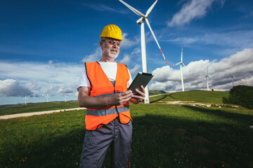 Male engineer on windmill farm for electric power production