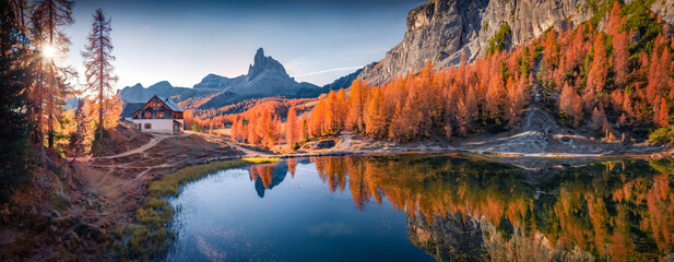 Panoramic autumn view of popular tourist destination - Federa lake. Picturesque sunrise in Dolomite Alps. Amazing morning scene of Italy, Europe. Beauty of nature concept background..