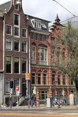 Amsterdam Raadhuisstraat Street View with Brick House Facades and Walking Man, Netherlands