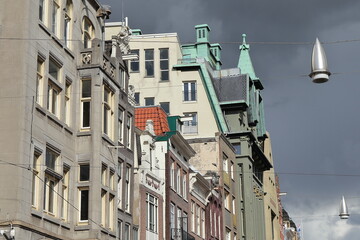 Amsterdam Damrak Street Building Facades Close Up with Grey Sky, Netherlands