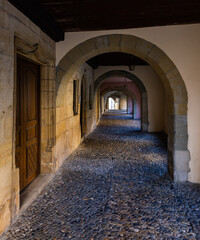 Fototapeta na wymiar Medieval passage with stone arches in Estavayer le lac, Switzerland