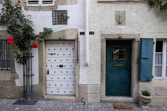 Historic door and roses in the medieval town of Estavayer le lac, Switzerland