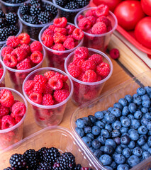 Berries raspberries and blackberries on the counter in the market.