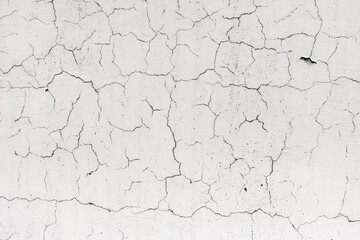 Cracked plaster on the wall of the house.