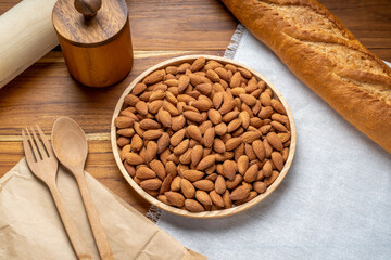 Roasted Almond on wooden table, Almond in wooden plate ready to serve.