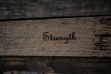 Old timber texture with text Strength