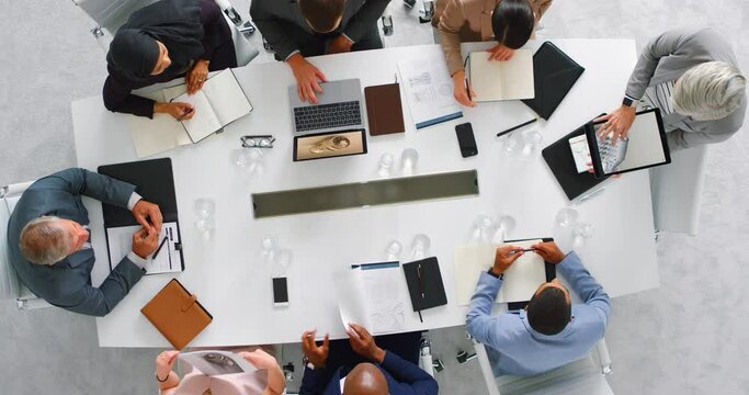 Meeting, teamwork and planning with technology in office with business people working on innovation, new product idea and marketing from above. Communication, vision and diversity during a proposal