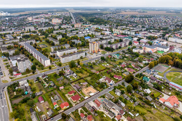 aerial panoramic view from a great height of a small provincial green town with a private sector and high-rise apartment buildings