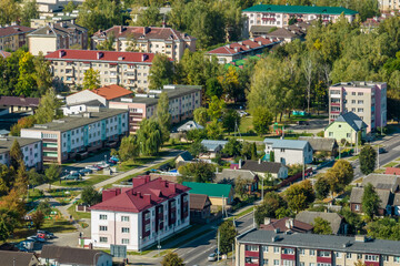 aerial panoramic view from a great height of a small provincial green town with a private sector and high-rise apartment buildings