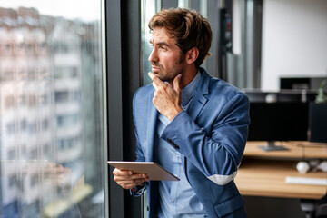 Portrait of frustrated stressed business man working in corporate office