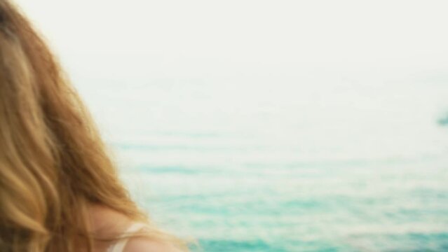 Smiling face happy young woman tourist enjoys top view seascape Spain. Summer nature rocks coast sea bright sunset, sun rays light flare. Blonde hair firl travel Costa Brava beach, city Lloret de Mar
