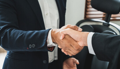 Businessman handshake for teamwork of business merger and acquisition,successful negotiate, two businessman shake hand with partner to celebration partnership and business deal concept.