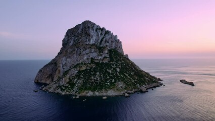 Aerial view of Es Vedra Ibiza during sunset. Showing ocean and clear skies. Cinematic 4K