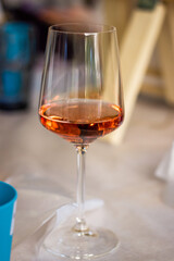 Glass with wine on the table among drawing accessories 