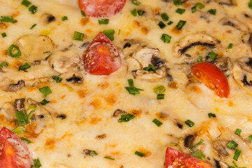 Cooked spicy pizza with meat and mushrooms, fragment close-up