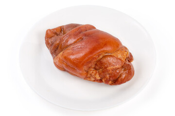 Boiled-smoked pork knuckle on a white plate