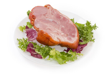 Boiled-smoked pork knuckle on the lettuce leaves on dish