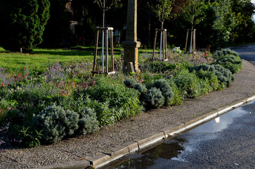 beautifully landscaped surroundings are decorated with a stone plinth. unpretentious drought loving...