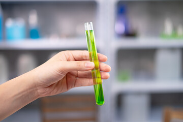 Close up look of Scientist is holding  
a test tube of the result from laboratory eco or natural cosmetic, medicine, Skin care, organic beauty treatment and essential oil experiment or research.