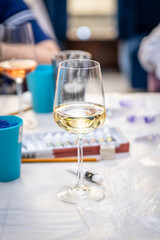 Glass with wine on the table among drawing accessories 