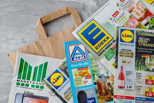 Edeka, Lidl, Aldi and Marktkauf supermarket brochures and paper shopping bag.
